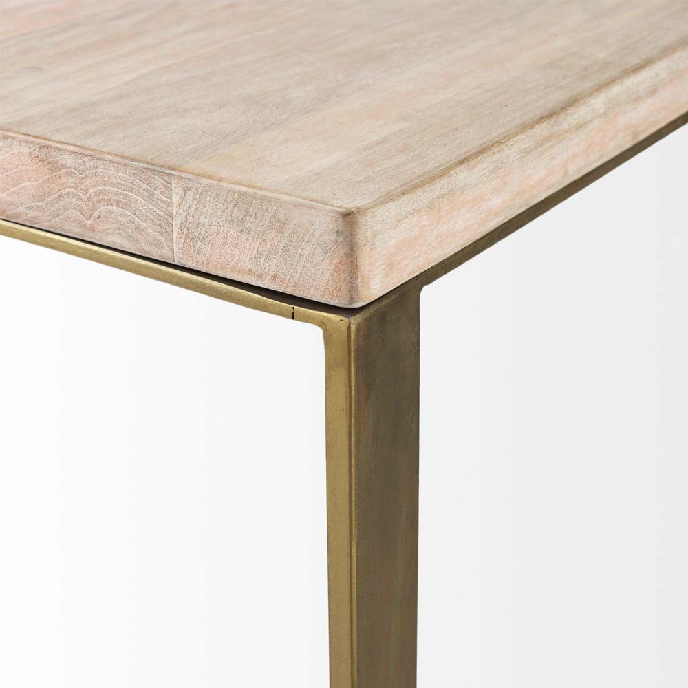 Close up of light brown wood on c-shaped side tableC style side table with light wood top and brass metal C shaped frame