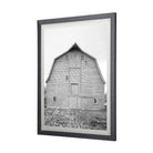 Large black and white barn print in a wood frame on a white background