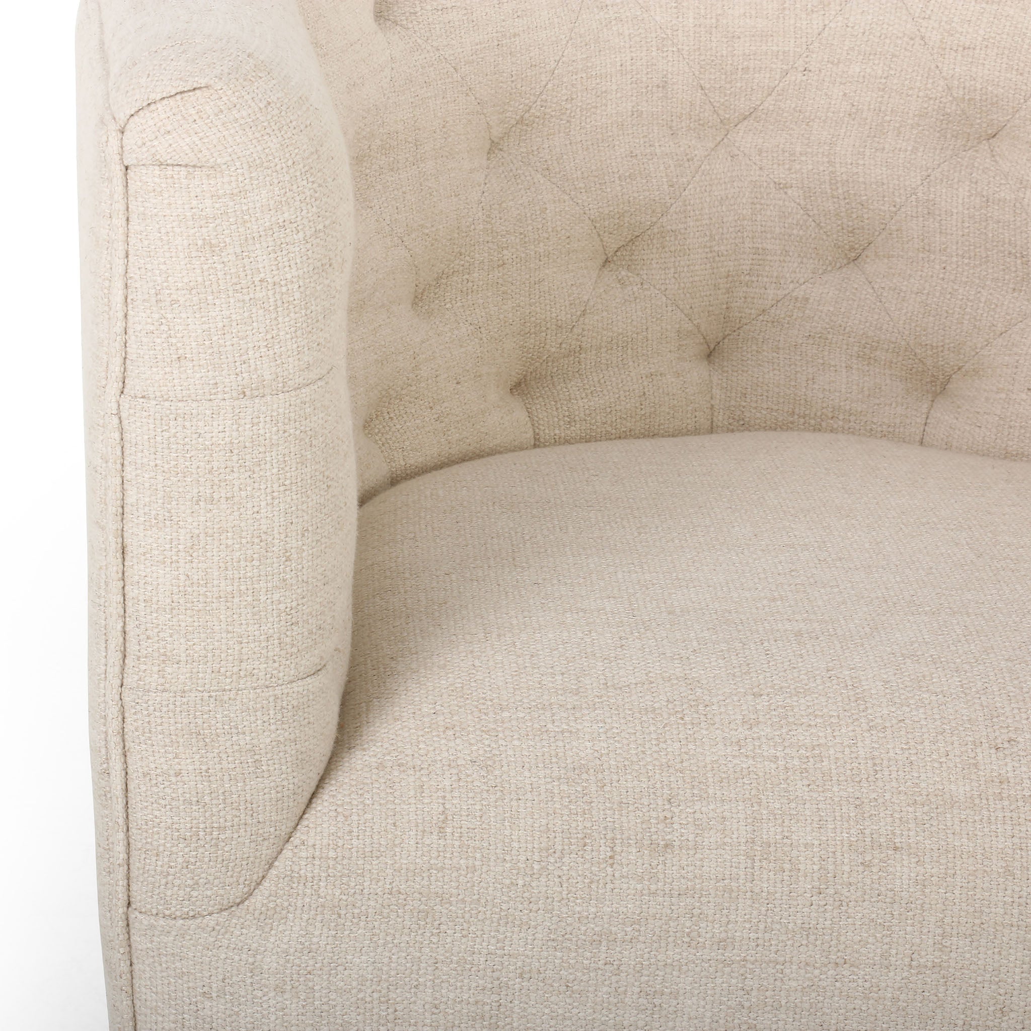 Close up of Barrel style 'Hanover' swivel chair upholstered in cream fabric by Four Hands furniture on a white background 