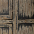 Close up of finish on Tall 'Hitchens' cabinet with worn black paint and two doors on a white background by Four hands furniture