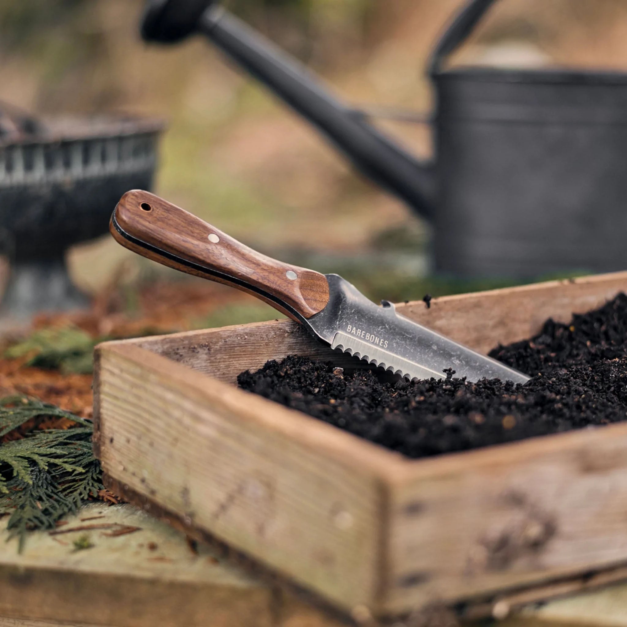 Barebones brand hori hori garden tool in wood box with dirt