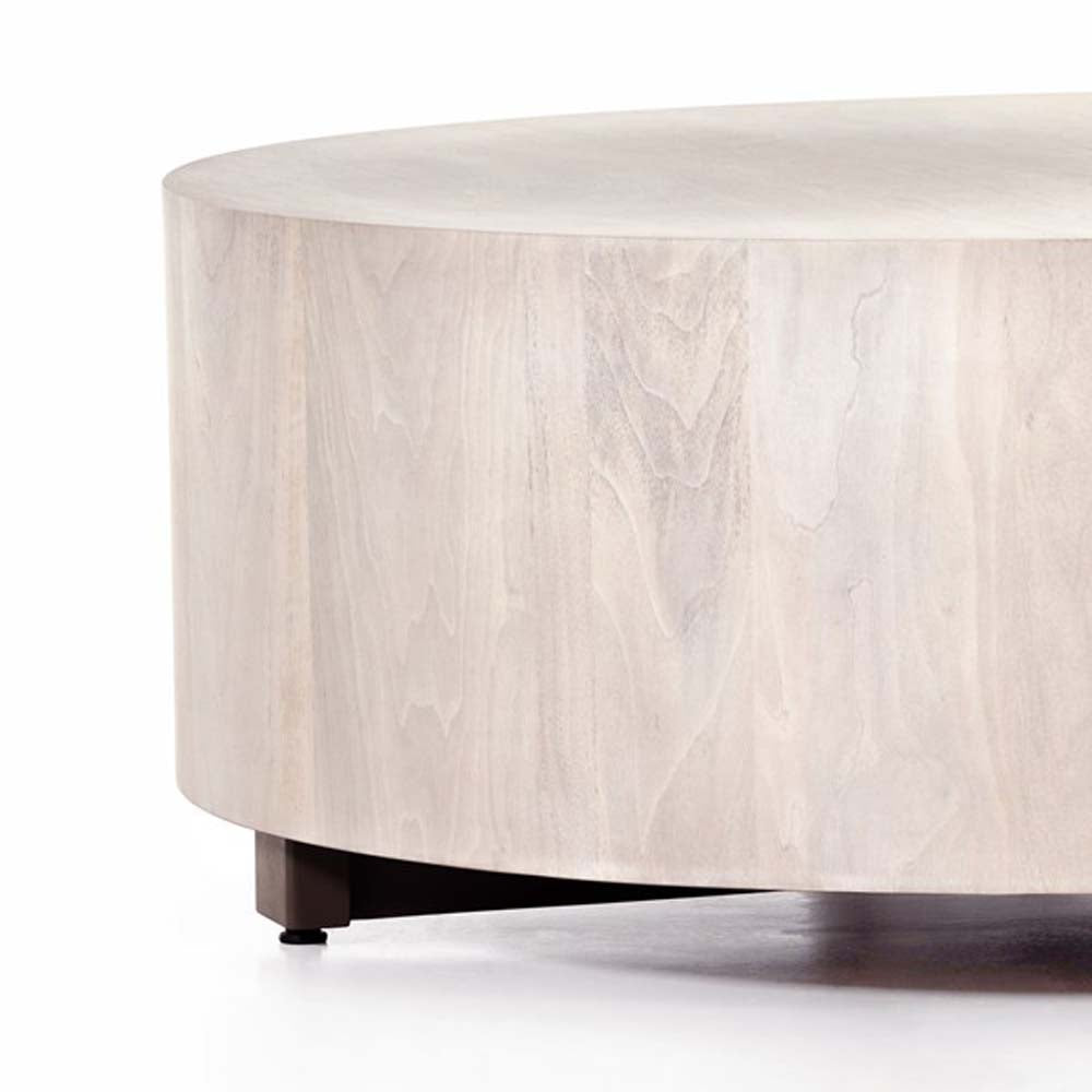 Hudson round coffee table by four hands in light wood Ashen walnut color with dark wood legs on a white background