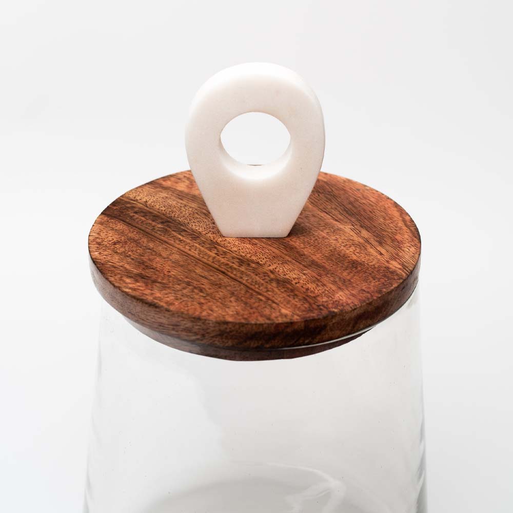 Glass jar with mango wood & marble lid closeup on a white background