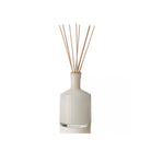 Lafco brand white glass feu de bois reed diffuser on a white background