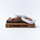 White marble decorative chain on stack of vintage book