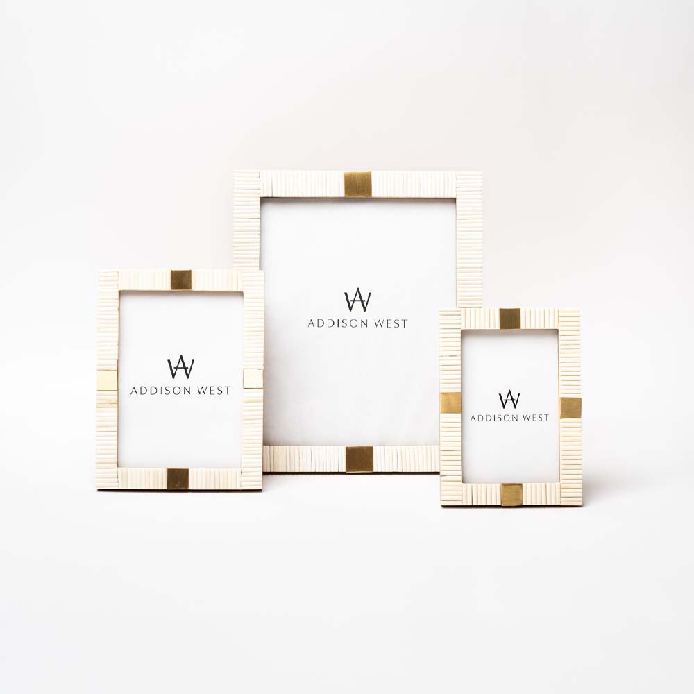 Three white bone inlay picture frames with gold accents in three sizes on a white background