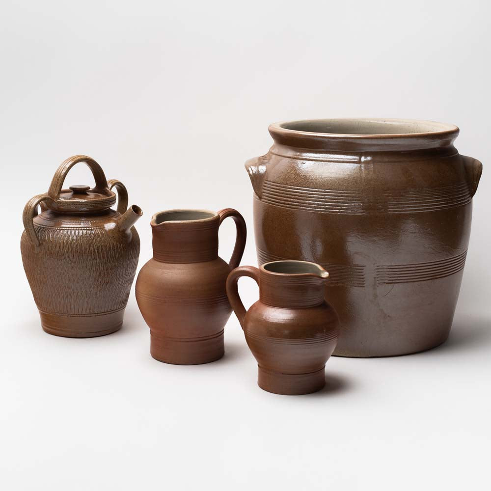 Collection of Poterie Renault jugs and jars on a white background