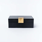 Black accent box with square brass accent on a white background.