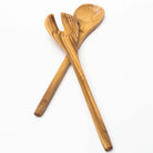 Set of olive wood salad servers on a white background