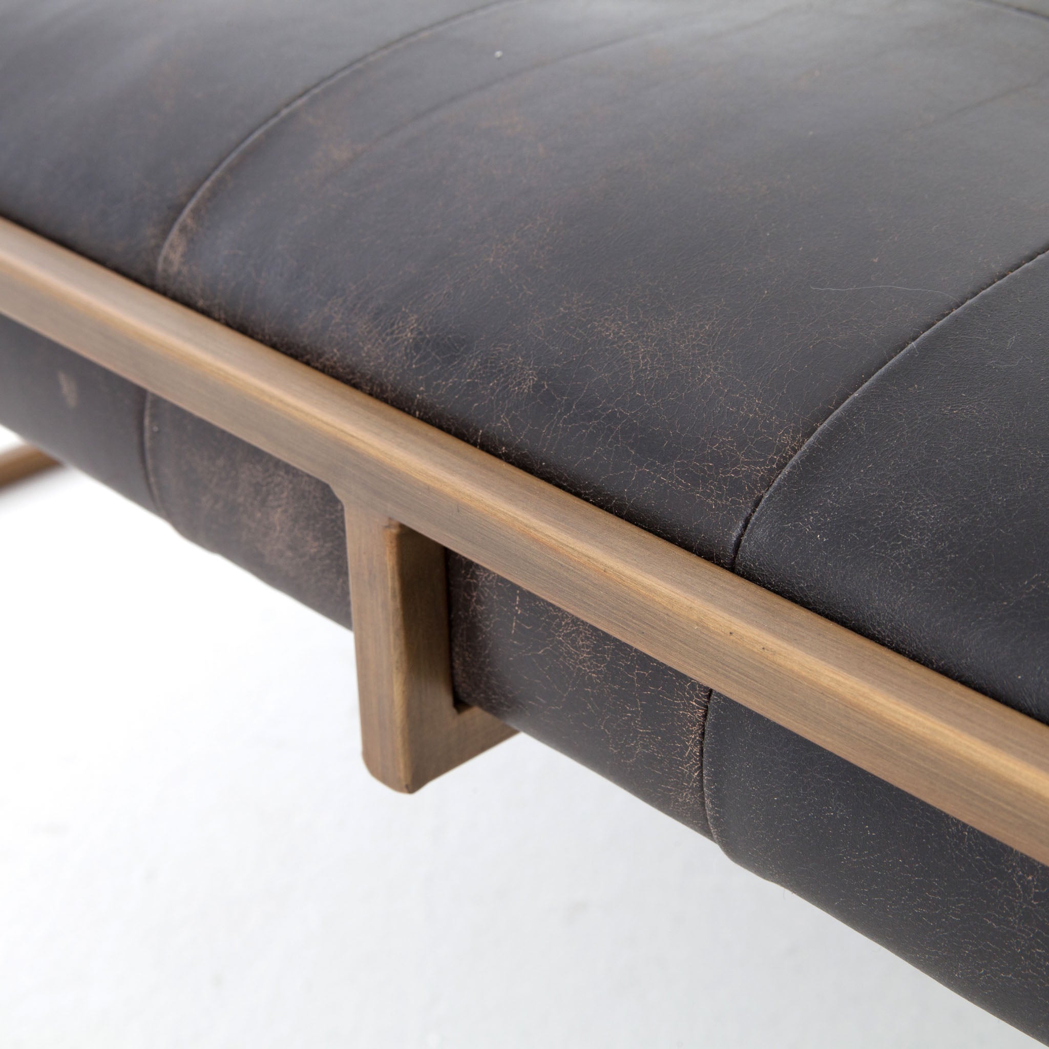 Four hands brand Oxford square coffee table with brass frame and black leather top on a white background