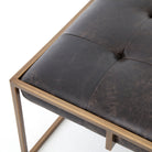 Four hands brand Oxford square coffee table with brass frame and black leather top on a white background