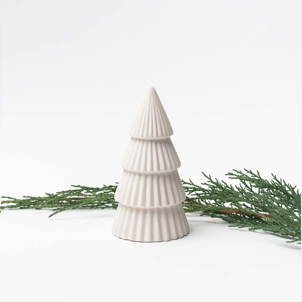 Small White ceramic decorative Christmas tree on white background