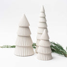 White ceramic decorative Christmas trees on white background