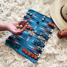 Pendleton brand backgammon set being played on a white shag rug