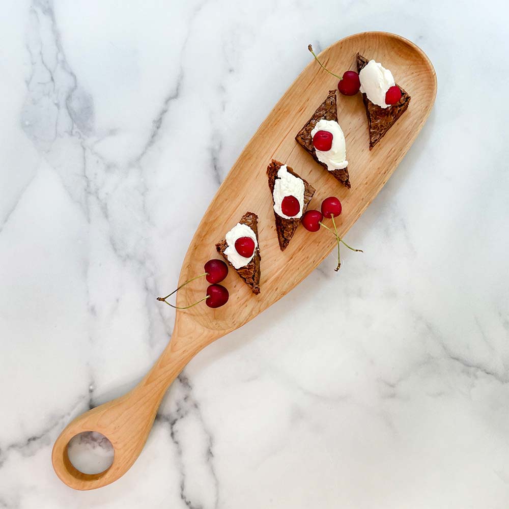 Thomas Shackleton 'intruder' board on a marple countertop with small appetizers displayed