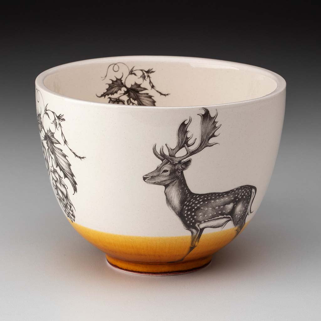 Laura Zindel fallow buck small bowl with amber glaze accent on a grey background