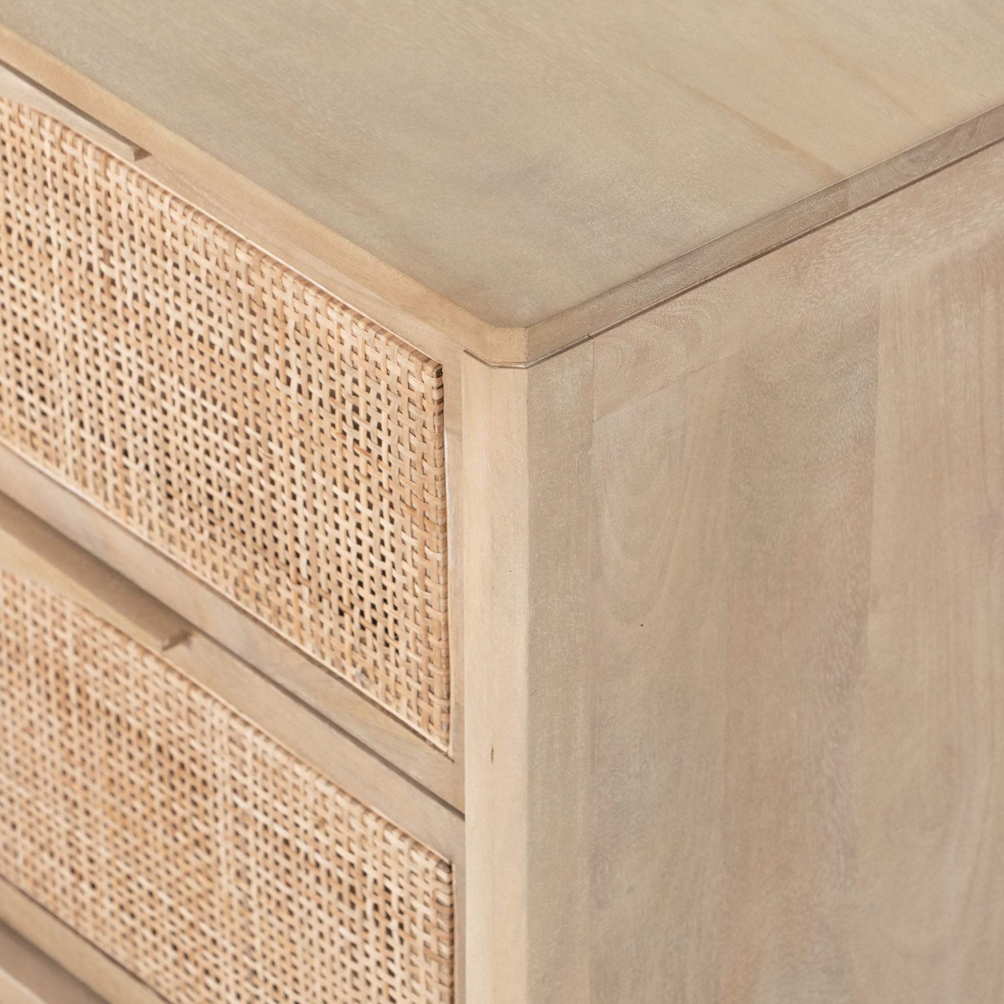 Six drawer 'Sydney' dresser with cane drawer fronts and mango wood pulls with natural mango wood exterior by Four Hands Furniture on a white background