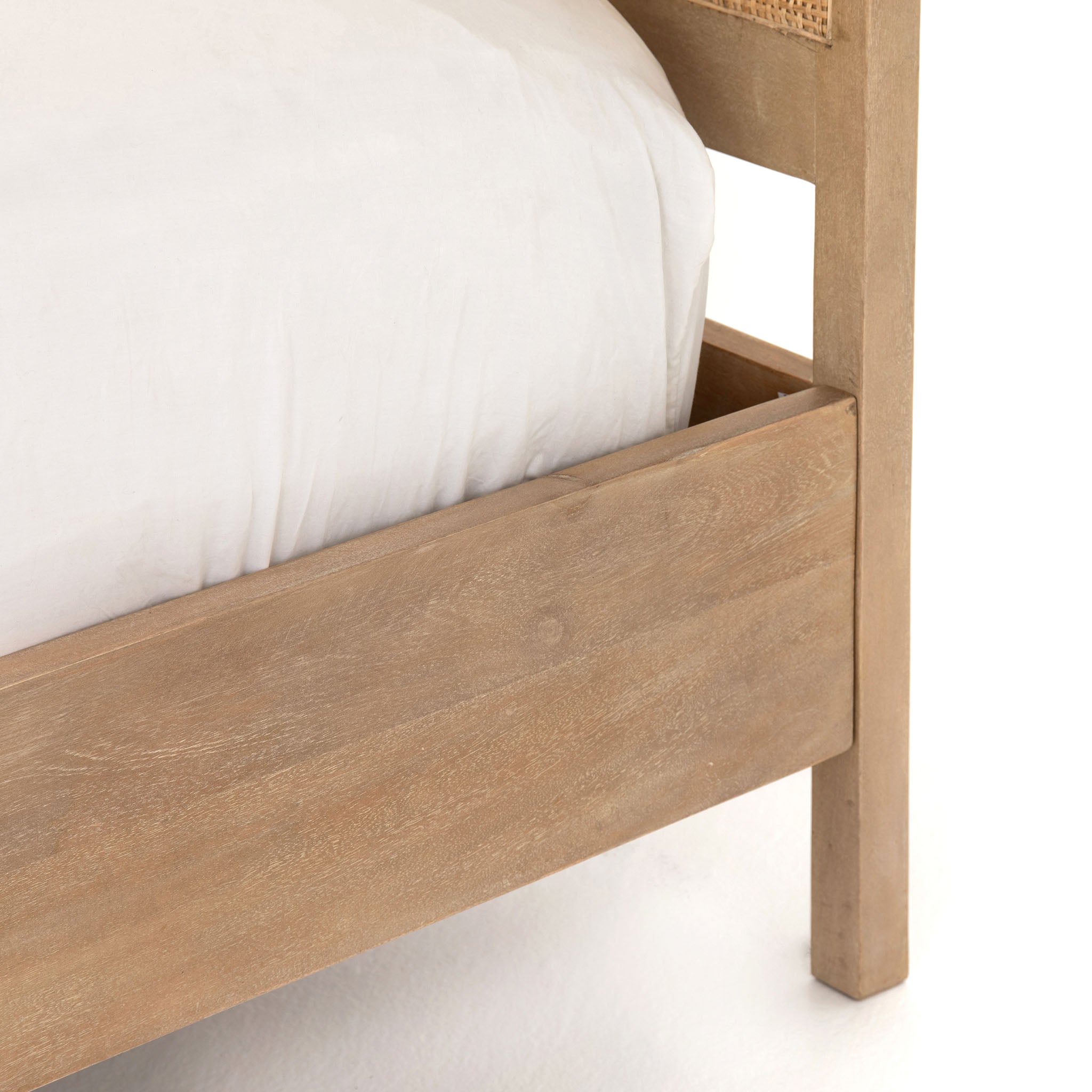 Natural wood and cane 'Sydney' bed by Four hands furniture on a white background