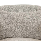 Close up of fabric on Four hands brand Topanga swivel chair with boucle grey and creme fabric on a white background