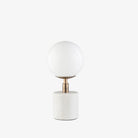 Surya brand Una table lamp with white marble base and white globe on a white background