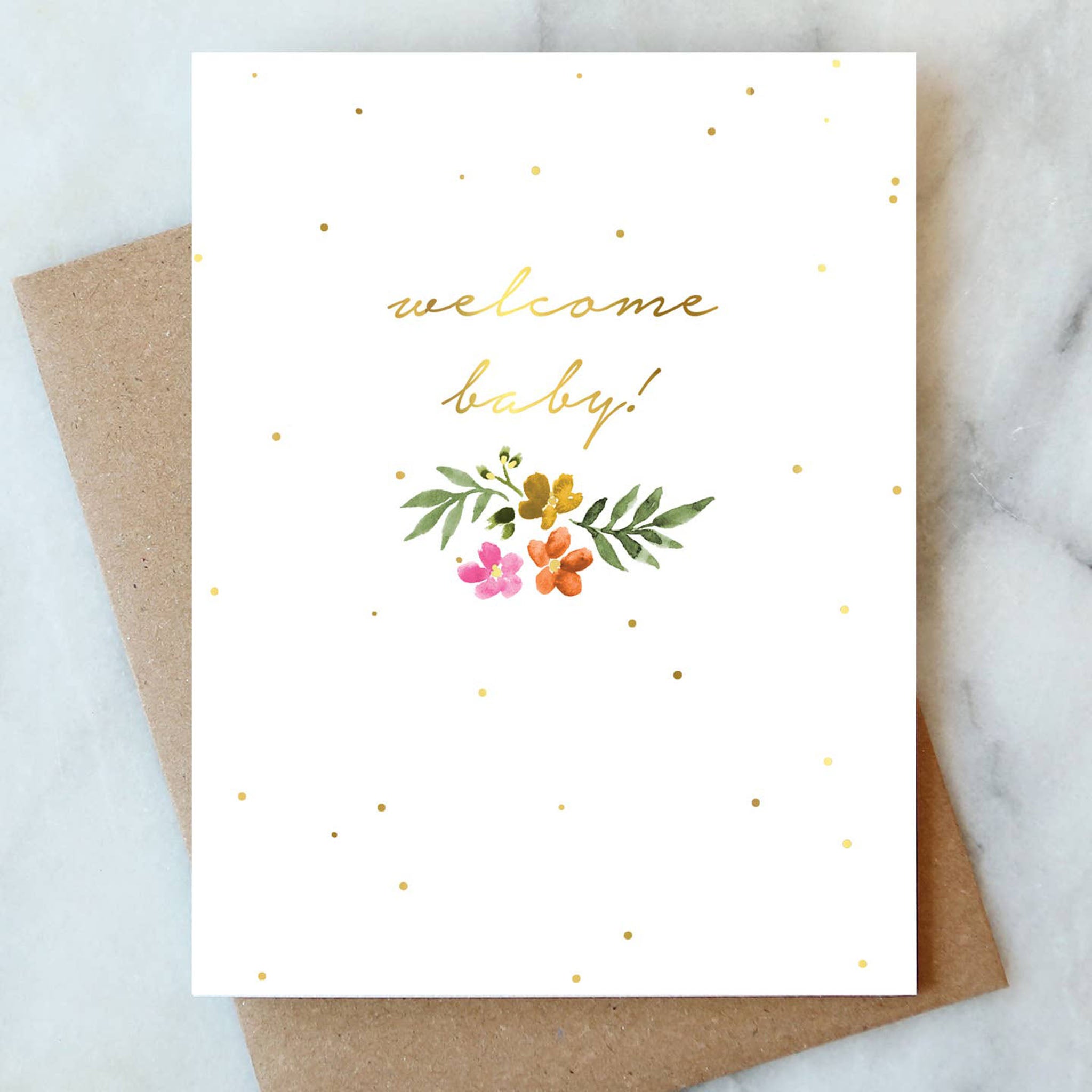 Welcome Baby Greeting Card on a white counter with craft brown envelope