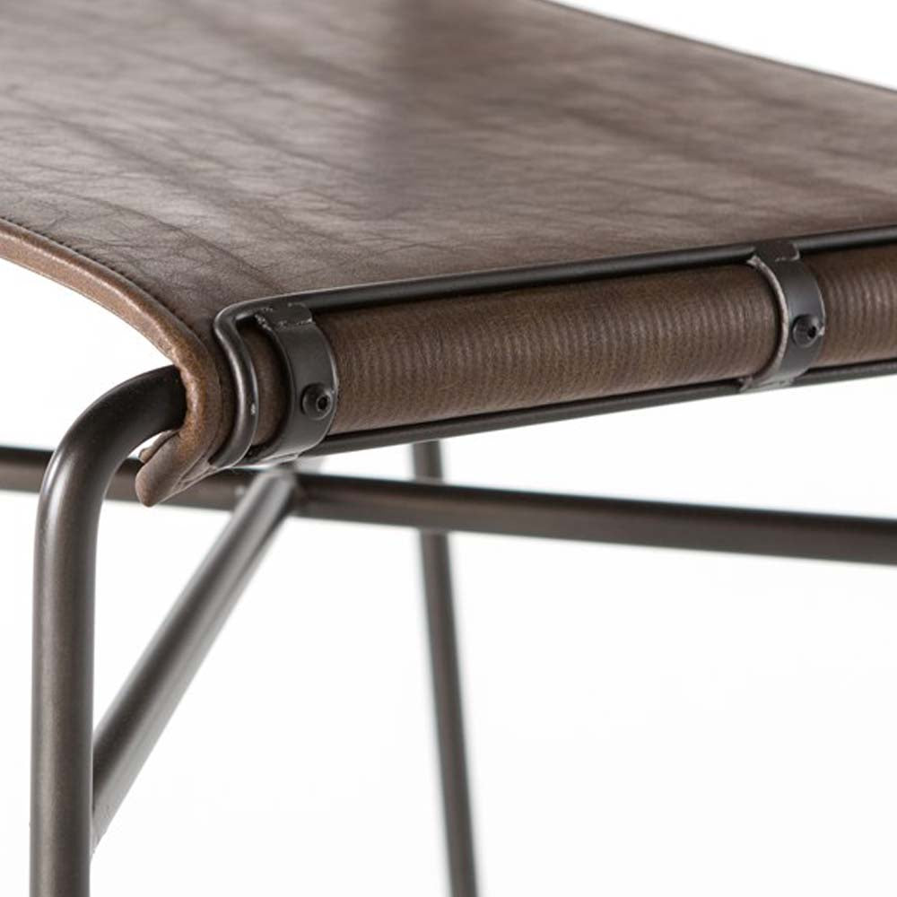 Close up view of Four hands brand wharton counter stool with black iron frame and dark brown leather seat on a white background