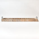 White washed rectangular rattan tray with black metal handles on a white background